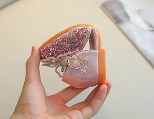 Détail de la semelle souple pliée sur des chaussures de princesse roses à paillettes