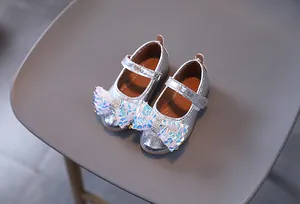 Dettaglio scarpe da principessa argento per bambina con fiocco di paillettes lucide