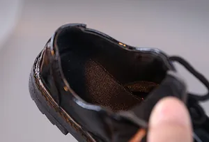 Detail of the breathable mesh lining and padded heel on these boys' leather shoes