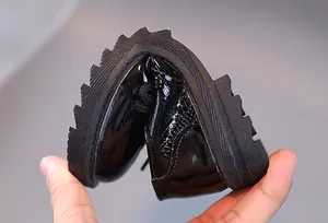 Detail showing the ultra-flexible non-slip rubber sole of these boys' black leather shoes
