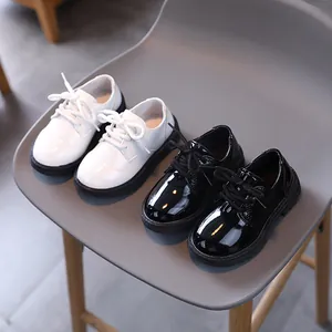 Classic kids lace-up patent leather shoes in black and white with thick rubber soles