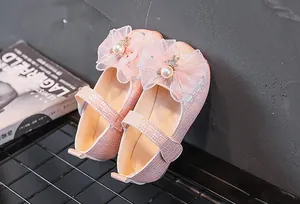 Gros plan chaussure Mary Jane rose pour fille avec nœud lapin perle et cuir tressé