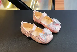 Detail of pink Mary Jane shoes for girls with rhinestone heart and tulle bow