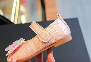 Close-up of pink woven leather Mary Janes with pearl luster and 3D floral bead detail