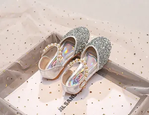 Détail de chaussures princesse argentées à paillettes avec perles et semelle intérieure