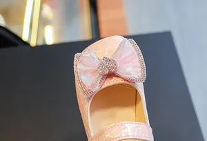 Close-up of pink girls Mary Jane shoe with mesh bow and sparkling crystal heart detail