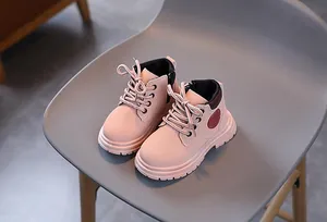 Detail view of pink girls boots featuring side zipper and lace-up closure design