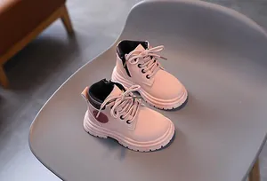Detail of pink girls' boots showing anti-slip rubber sole and side zipper closure