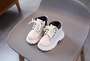 Detail of cream children's martin boots featuring side zipper and thick anti-slip rubber sole