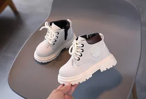 Detailed side view of off-white kids martin boots with fashion label and thick sole