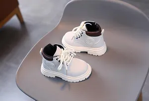 Detailed side view of beige kids boots with brown collar and side zipper closure
