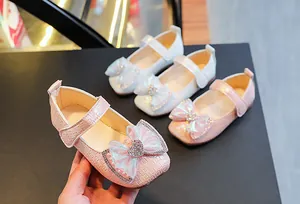 Detail of girls' mary jane shoes with mesh bow, heart rhinestone and velcro strap