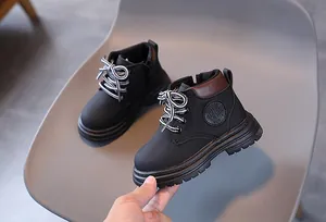 Detail view of children's black martin boots with side zipper and striped laces