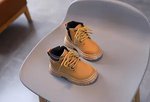 Detailed view of kids classic yellow boots with anti-slip rubber soles and side zippers