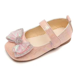 Iridescent pink Mary Jane shoes for girls with rhinestone bow and velcro strap