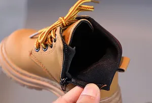 Detail showing smooth side zipper on brown yellow kids classic work boots for easy wear