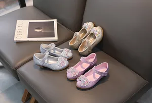 Detail of glitter girls' princess shoes with sequin bows and pearls in silver, purple, gold