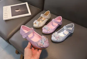 Close-up of glitter sequins, rhinestones, and bow details on colorful princess shoes
