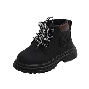 Detailed side view of black children's boots with rugged anti-slip soles and round laces