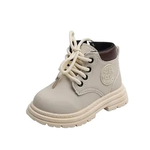 Detailed side view of cream kids' chunky boots with anti-slip thick rubber soles