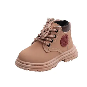 Detail view of tan children's ankle boots featuring sport fashion side patch and lace-up design