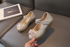 Detailed macro view of sequin kids princess shoes with rhinestone bow and velcro strap