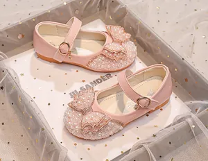 Detail of pink princess shoes featuring double bows with faux pearls and rhinestones