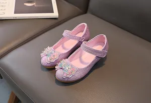 Detail of pink sequin Mary Jane shoes for girls featuring a rhinestone bow and velcro strap