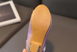Detailed view of durable anti-slip rubber sole and purple sequins on girls' princess shoes