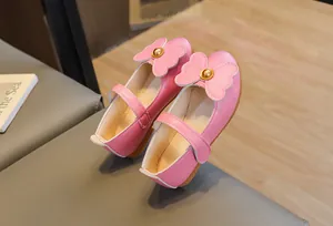 Detailed view of pink Mary Jane shoes for girls with large bow and non-slip sole