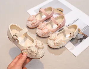 Detail of girls princess shoes featuring pearl bows, rhinestone accents and star charms