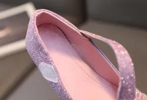 Macro shot of pink glitter girls' shoes with velcro strap and sequin leather detail