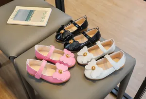 Detail of girls' Mary Jane shoes in black, pink, and white with bowknot and durable gum sole