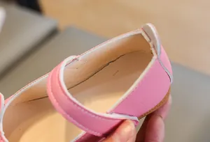 Detailed view of pink girls' leather princess shoes with bow and soft sole