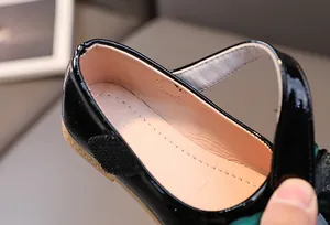 Macro view of black patent leather Mary Jane shoes showing inner lining and stitching