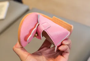Detail shot showing the high flexibility and soft pink leather of the baby princess shoes