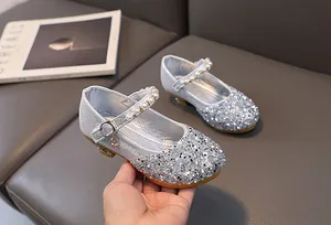 Detailed view of silver sequin Mary Jane shoes with pearl strap and non-slip sole