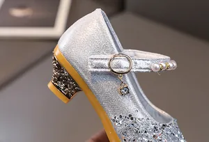 Detailed close-up of sparkling silver sequins and pearl strap on girls princess heels