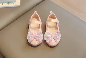 Detailed top view of pink girls Mary Jane shoes with rhinestone bow and velcro straps