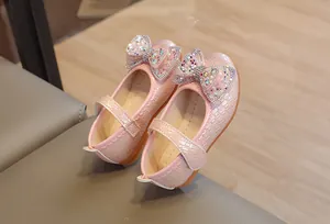 Dettaglio scarpe Mary Jane rosa per bambine con fiocco di strass e decori glitter