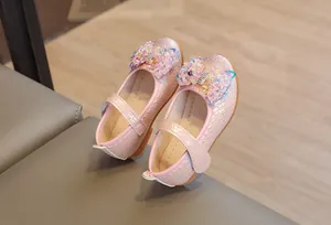 Détail de chaussures Mary Jane roses avec nœud perlé et similicuir texturé pour filles