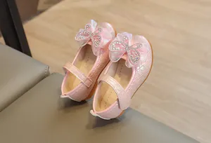 Detail of pink girls' Mary Jane shoes featuring a glittery rhinestone mesh bow