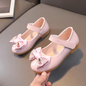 Pink glossy patent leather Mary Jane shoes for girls with cute glittery bow detail