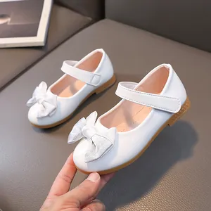 White patent leather girls Mary Jane shoes with silver glitter bow and non-slip sole