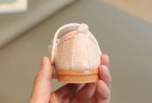 Detail of pink girls princess shoe showing woven texture and anti-slip rubber sole