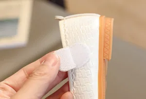 Detail of white girls princess shoe featuring a velcro strap and textured finish