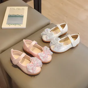 Pink and white Mary Jane shoes for girls with rhinestone bows and crocodile texture
