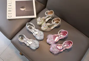 Detailed view of girls' glitter princess shoes with rhinestone bows in gold silver and pink