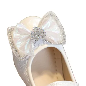 White girls princess shoes featuring a large rhinestone heart bow and woven texture