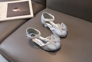 Detailed view of silver sequin girls princess shoes with large gradient bow and pearls